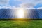 Rows of solar panels in a field on a background of green grass