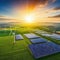 Rows of solar panels and wind turbines on green landscape hybrid renewable energy