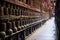 rows of spinning prayer wheels near monastery