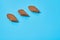 Rows of three brown spicy pieces of rusk bread lies on blue desk in sport bar or pub