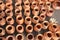 Rows of unglazed clay pottery jars, jugs and pots for cooking without lids