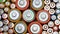 Rows of used alkaline AA, AAA, D batteries. Lithium ion battery pack close up