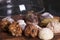 Rows of various shortbread and oat cookies with cereals and raisin on black wooden background. Top view.