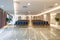 Rows of vintage blue chairs on beige glossy marble floor in modern light hall interior of luxury auditorium office building