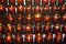 Rows of votive candles in red glass