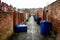 Rows of wheelie bins waiting for collection on a run down backstreet