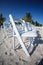 Rows of white chairs on beach