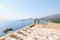 Rows of white chairs at the wedding arch on the observation deck above the sea