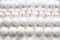 Rows of white New Year\\\'s toys. Balls and bears