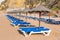 Rows of wicker parasols and beach beds