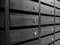 Rows of wooden unnumbered mailboxes and lockers