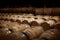 Rows of wooden wine barrels at wine Cellar