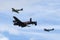 Royal Air Force Battle Of Britain Memorial Flight Avro Lancaster bomber PA474 flying in formation with two Supermarine Spitfires.