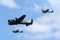 Royal Air Force Battle Of Britain Memorial Flight Avro Lancaster bomber PA474 flying in formation with two Supermarine Spitfires.