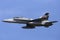 Royal Australian Air Force RAAF McDonnell Douglas F/A-18B Hornet jet aircraft A21-110 flying against a blue sky.