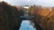 Royal Baths Park Flying over the water surrounded by autumn colored trees Baths Palace in the distance