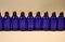 Royal blue glass dropper bottles with corks.