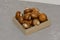 Royal brown champignons - Agaricus bisporus. Fresh mushrooms in wooden box on concrete gray background