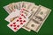 Royal Flush Hearts And Dollar Money On Green Felt