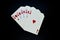 Royal flush straight flush of hearts cards in poker game against black background