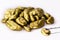 Royal gold nuggets heaped on isolated white background, rare stones mining concept