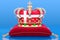 Royal golden crown on pillow with the Kingdom of Denmark flag, 3D rendering