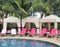 Royal Hawaiian Hotel, Honolulu, Hawaii -4/27/2018 - Lounge chairs and umbrellas by the pool at the Royal Hawaiian Hotel in Hawaii