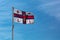 Royal National Lifeboat Institution RNLI flag flying above the lifeguard station in Southwould, UK