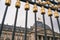 The Royal Palace in Brussels, Belgium. View through the metal fence with golden details. National flag of the Kingdom of