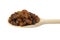 Royal raisins on wooden spoon isolated on white background. Spice and food ingredients