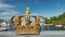 Royal Swedish crown on the Skeppsholmbron bridge over the river with harbor in the background.