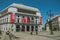 Royal Theatre on busy square with people and light post in Madrid