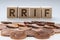 RRIF letters on wooden blocks with coins on a clear background