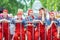 Rtists of the theater group in red overalls and scarves take part in the festive procession of high school graduates