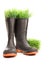 Rubber boots with grass on white