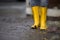 Rubber Boots are standing in a dirty puddle