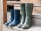 Rubber boots standing on the wooden steps of the village house