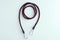 Rubber cord for securing luggage with metal carabiners on white background