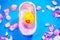 Rubber duck in the bathtub, colorful background with shells, rose petals and other rubber ducks, rubber ducks