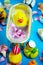 Rubber duck in the bathtub, colorful background with shells, rose petals and other rubber ducks, rubber ducks