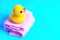 Rubber duck placed on a pile of bath towels
