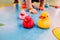 Rubber ducklings with which a girl plays, unfocused background