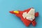 Rubber fighter plane toy display on blue background view