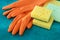 Rubber gloves with colorful kitchen sponges, housekeeping. Cleaning service concept, housework. Dish scrubber