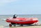 Rubber lifeguard boat trailer on sea shore