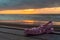 A rubber pink sandal on the beach by the Atlantic Ocean