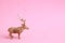Rubber reindeer toy isolated on a pink background