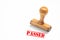 Rubber stamp with passed sign on white background