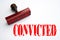 Rubber stamp with the word CONVICTED