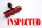 Rubber stamp with the word INSPECTED